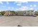 A charming yellow apartment building with classic architecture and a spacious parking area for convenient resident parking at 9895 1St E St # 5, Treasure Island, FL 33706