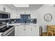 Close-up of updated kitchen features, including stainless steel appliances and white quartz countertops at 9895 1St E St # 5, Treasure Island, FL 33706