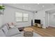 Bright living room featuring modern shiplap accent wall and hardwood floors at 9895 1St E St # 5, Treasure Island, FL 33706