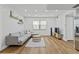 Open-concept living room with hardwood floors, modern decor, and lots of natural light at 9895 1St E St # 5, Treasure Island, FL 33706