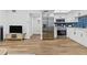 Open living area showcasing a modern kitchen, dining space, and a cozy living room at 9895 1St E St # 5, Treasure Island, FL 33706