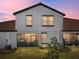 This is the back exterior of the home with a lawn at 17308 Holly Well Ave, Wimauma, FL 33598