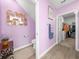 Hallway with a powder room, walk in closet, and hexagon mirror decor at 17308 Holly Well Ave, Wimauma, FL 33598