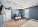 Bedroom featuring blue walls, carpet flooring, and a ceiling fan at 17308 Holly Well Ave, Wimauma, FL 33598