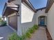 Inviting front entrance with a teal door, brick walkway, and a well-maintained garden at 17308 Holly Well Ave, Wimauma, FL 33598