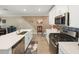 Contemporary kitchen featuring stainless steel appliances, white cabinets and stylish backsplash at 17308 Holly Well Ave, Wimauma, FL 33598