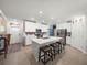 Bright kitchen with an island, stainless steel appliances, white cabinets, and seating for three at 17308 Holly Well Ave, Wimauma, FL 33598