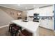 Spacious kitchen with an island, stainless steel appliances, white cabinets, and bar stool seating at 17308 Holly Well Ave, Wimauma, FL 33598