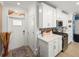 Bright kitchen with white cabinets, stainless steel appliances, and a mosaic backsplash at 17308 Holly Well Ave, Wimauma, FL 33598