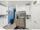 Eat-in kitchen showcasing stainless steel appliances, white cabinets, and a stainless steel refrigerator at 17308 Holly Well Ave, Wimauma, FL 33598