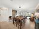 Open concept living room and dining room showcasing tiled floors, large windows, and comfortable seating at 17308 Holly Well Ave, Wimauma, FL 33598