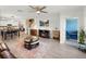 Open-concept space features living, dining, and kitchen areas with hardwood floors and neutral decor at 17308 Holly Well Ave, Wimauma, FL 33598