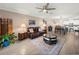 Comfortable living room open to dining area, featuring neutral tones and ample seating at 17308 Holly Well Ave, Wimauma, FL 33598
