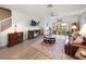 Cozy living room with hardwood floors, a ceiling fan, and sliding doors to the outdoor patio at 17308 Holly Well Ave, Wimauma, FL 33598