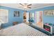 Bright main bedroom featuring an electric fireplace, ceiling fan, and adjacent bathroom and sitting room at 17308 Holly Well Ave, Wimauma, FL 33598