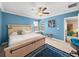 Serene main bedroom with blue walls, carpet, and large windows, creating a relaxing retreat at 17308 Holly Well Ave, Wimauma, FL 33598