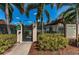 Community pool entrance with gated access, palm trees, and well-maintained landscaping at 1003 Hammock Pine Blvd # 1003, Clearwater, FL 33761