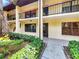 A well-maintained condo exterior featuring balconies, lush landscaping, and a welcoming entrance at 1003 Hammock Pine Blvd # 1003, Clearwater, FL 33761