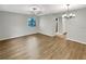 Open living room with modern chandelier and wood-look flooring, perfect for entertaining at 1003 Hammock Pine Blvd # 1003, Clearwater, FL 33761