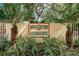Hammock Pine Entrance sign with lush landscaping, framed by palm trees at 1003 Hammock Pine Blvd # 1003, Clearwater, FL 33761