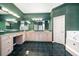 Green-themed bathroom with double sinks, vanity, and a tub at 109 Live Oak Ln, Largo, FL 33770