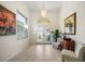 Elegant foyer with high ceilings, tile flooring, decorative chandelier, and double front doors at 109 Live Oak Ln, Largo, FL 33770