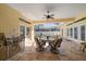 Covered patio with ceiling fan, dining table, and grill, perfect for outdoor dining and entertaining at 109 Live Oak Ln, Largo, FL 33770