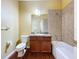 A full bathroom with a tiled shower-tub, vanity, framed mirror, and a toilet at 11212 Port Douglas Dr, New Port Richey, FL 34654