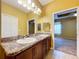 Bathroom featuring double sinks with granite countertops and a large mirror at 11212 Port Douglas Dr, New Port Richey, FL 34654