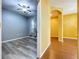 A bedroom showcasing modern flooring, a ceiling fan, and a window for natural light at 11212 Port Douglas Dr, New Port Richey, FL 34654