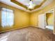 Bedroom with a modern ceiling fan, neutral carpeting, and a window providing natural light at 11212 Port Douglas Dr, New Port Richey, FL 34654