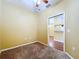 Bedroom showing neutral carpet, fresh paint and view to kitchen at 11212 Port Douglas Dr, New Port Richey, FL 34654