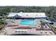 Aerial view of community pool, with lots of lounge chairs, tables, and built-in spa at 11212 Port Douglas Dr, New Port Richey, FL 34654