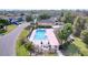 Aerial view of community pool, with lounge chairs and shaded picnic area at 11212 Port Douglas Dr, New Port Richey, FL 34654