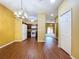 Open dining area with wood floors, stylish light fixture, and view into the living room and kitchen at 11212 Port Douglas Dr, New Port Richey, FL 34654