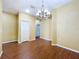 Dining room featuring hardwood floors, natural light, and a chandelier at 11212 Port Douglas Dr, New Port Richey, FL 34654