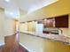 Bright kitchen featuring a breakfast bar, white appliances, and dark cabinetry at 11212 Port Douglas Dr, New Port Richey, FL 34654