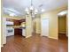 Eat-in kitchen featuring white appliances, wood cabinets, granite countertops, and wood flooring at 11212 Port Douglas Dr, New Port Richey, FL 34654