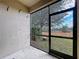 A screened lanai offering views of a backyard with green vegetation and a distant horizon at 11212 Port Douglas Dr, New Port Richey, FL 34654