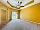 Spacious living room with modern ceiling fan, neutral carpeting, and sliding door access to the backyard at 11212 Port Douglas Dr, New Port Richey, FL 34654