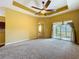 Spacious living room with a modern ceiling fan, neutral carpeting, and sliding doors providing outdoor access at 11212 Port Douglas Dr, New Port Richey, FL 34654