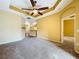 Spacious living room with a modern ceiling fan, neutral carpeting, and view to kitchen at 11212 Port Douglas Dr, New Port Richey, FL 34654