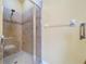 Tiled shower with glass door at 11212 Port Douglas Dr, New Port Richey, FL 34654