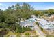 Aerial view of the charming home showing the driveway, yard, neighborhood, and unique mural on the garage at 1166 Granada St, Clearwater, FL 33755