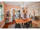 Stylish dining room with hardwood floors, modern lighting, and an open layout to the kitchen and living room at 1166 Granada St, Clearwater, FL 33755