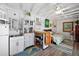 Living area with white walls, exposed ceiling beams, kitchenette and nautical decorations at 1166 Granada St, Clearwater, FL 33755