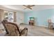 Cozy living room featuring wood-look flooring, a ceiling fan, and comfortable seating area at 1180 San Remo Dr, Largo, FL 33770