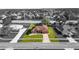 Monochrome aerial view of a single-story home with a well-manicured lawn and established landscaping at 13481 Pullman Dr, Spring Hill, FL 34609