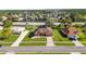 Aerial view of a neighborhood street featuring a cozy single-story home with manicured lawn and landscaping at 13481 Pullman Dr, Spring Hill, FL 34609