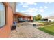 Wide shot of the brick paver patio with comfortable seating and outdoor kitchen at 13481 Pullman Dr, Spring Hill, FL 34609